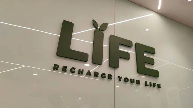 Life Clinics logo — Recharge Your Life — on a clinic wall