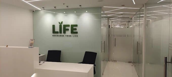 Life Clinics reception desk with the brand logo on the wall